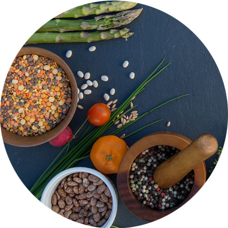 beans and vegetables scattered on a stone board