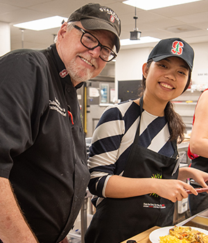 Chef Nijo and a Stanford students inside the Arrillaga Family Dining Commons