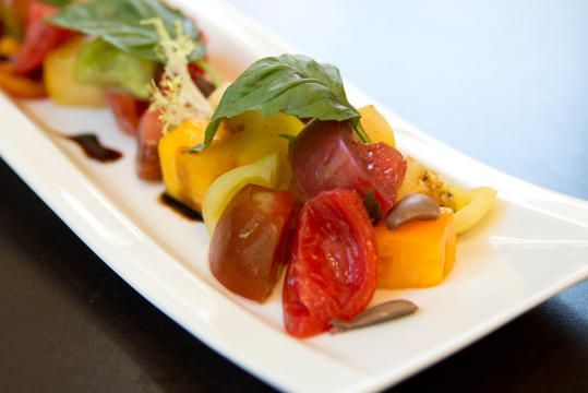 Plated entree with tomatoes