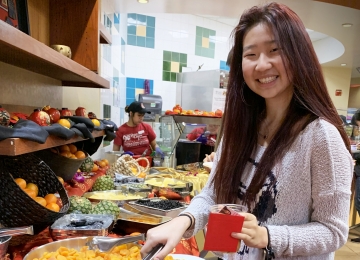 Bessie Zhang, ’24, samples the selection of dried fruits